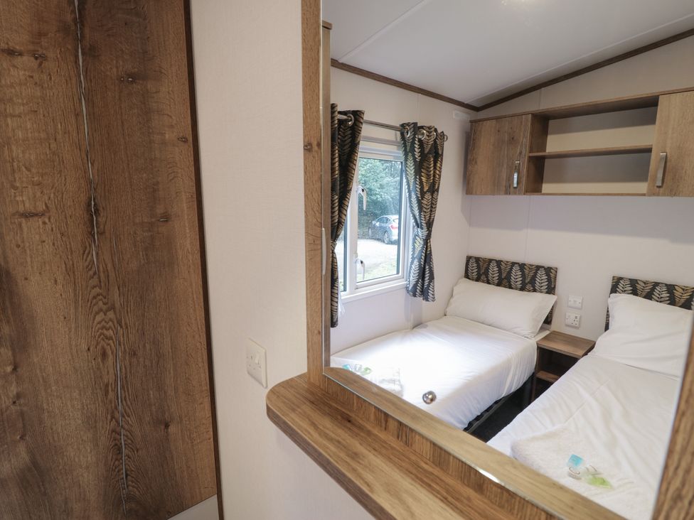 A bedroom with two beds and a window at Woodlands Gold (WO40) in Ruthin