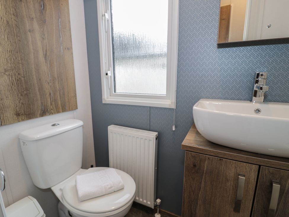 A bathroom with a toilet and sink at Woodlands Gold (WO40) in Ruthin