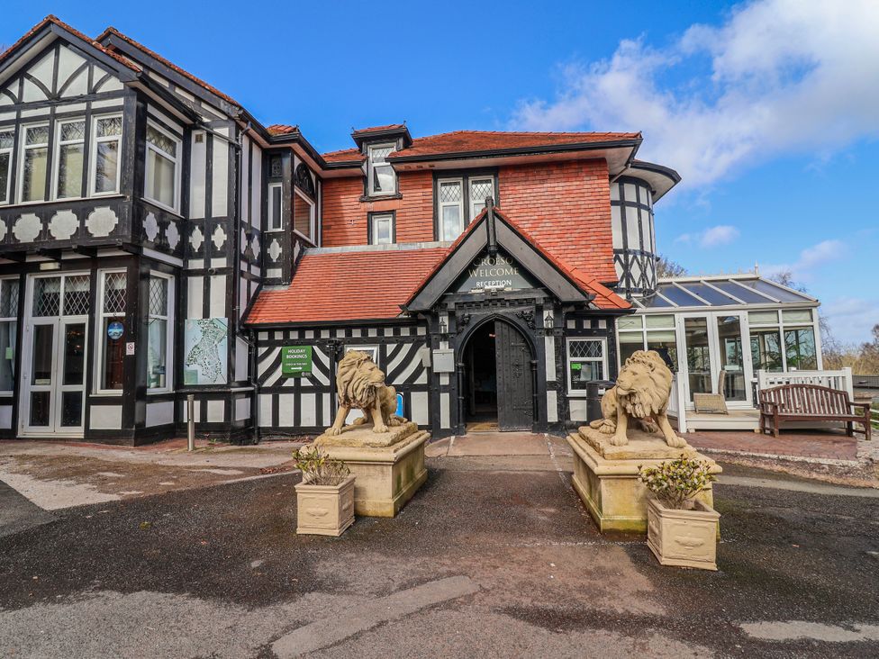 The entrance of a building with lion statues at Woodlands Gold in Ruthin