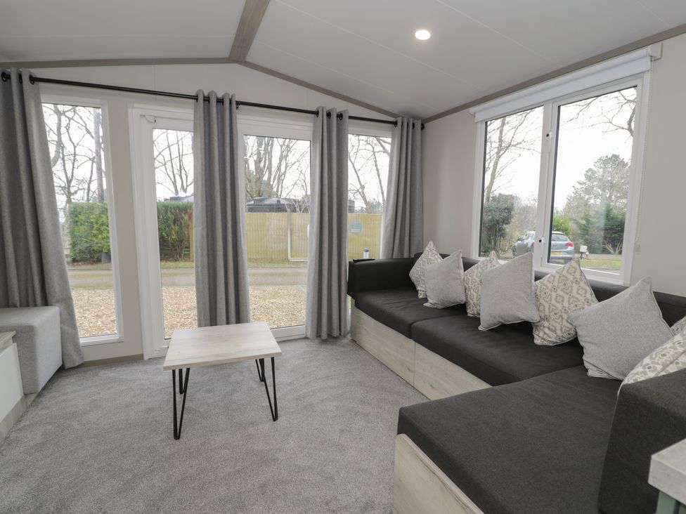 A living room with a sofa and coffee table at Woodlands Gold (WO06) in Ruthin