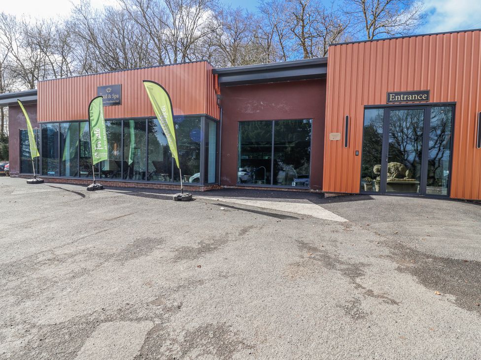 A building entrance with flags outside at Woodlands Gold (WO06) in Ruthin