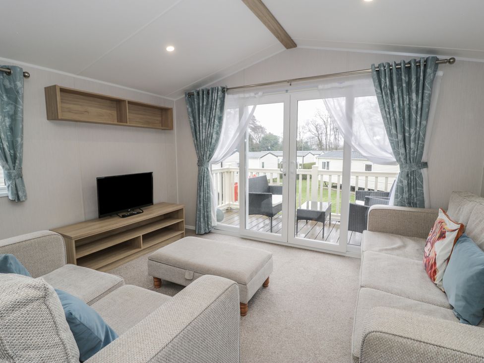 A living room with a sofa and television at Woodlands Platinum (WO29) in Ruthin