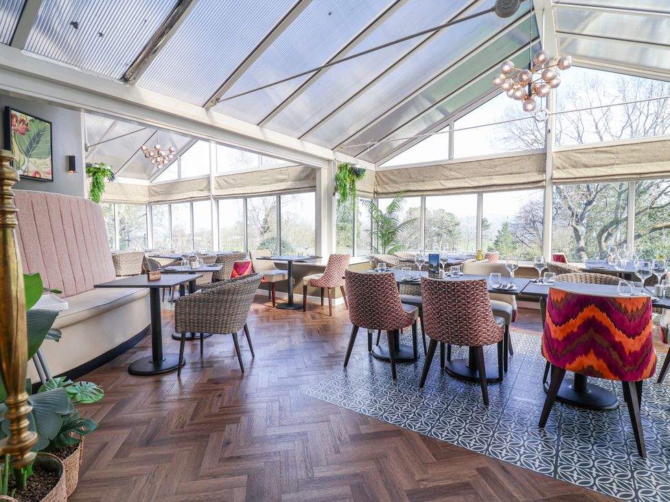 A dining room with tables and chairs at Woodlands Platinum (WO29) in Ruthin