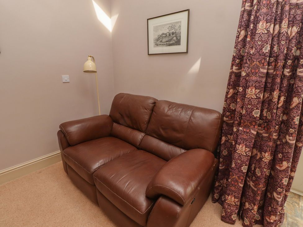 A living room with a sofa and lamp at Annex in Morpeth
