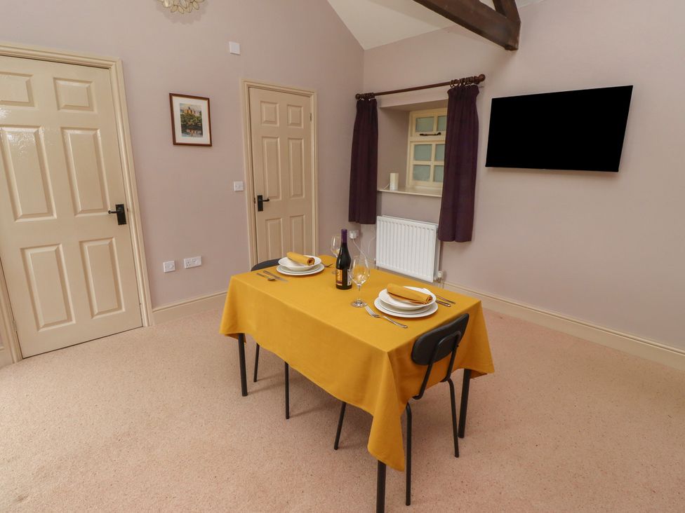 A dining room with a table set for dinner at Annex in Morpeth