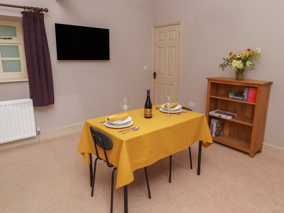 A dining room with a table set for dinner at the Annex in Morpeth