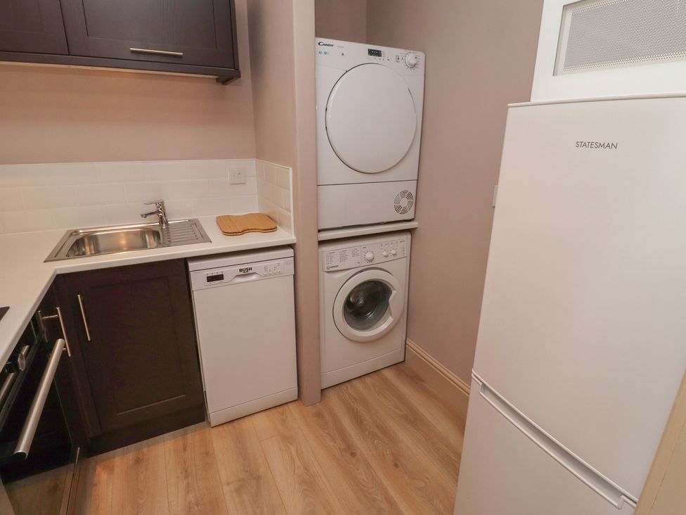 A kitchen with appliances including a sink, dishwasher, washing machine, and tumble dryer at Annex in Morpeth