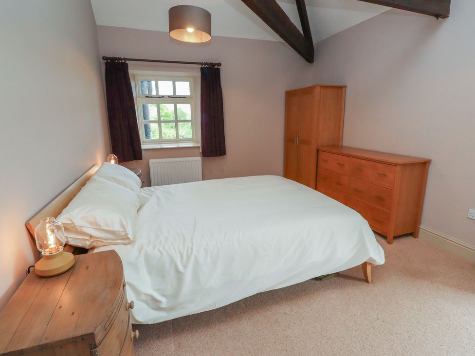 A bedroom with a bed and dresser at Annex in Morpeth