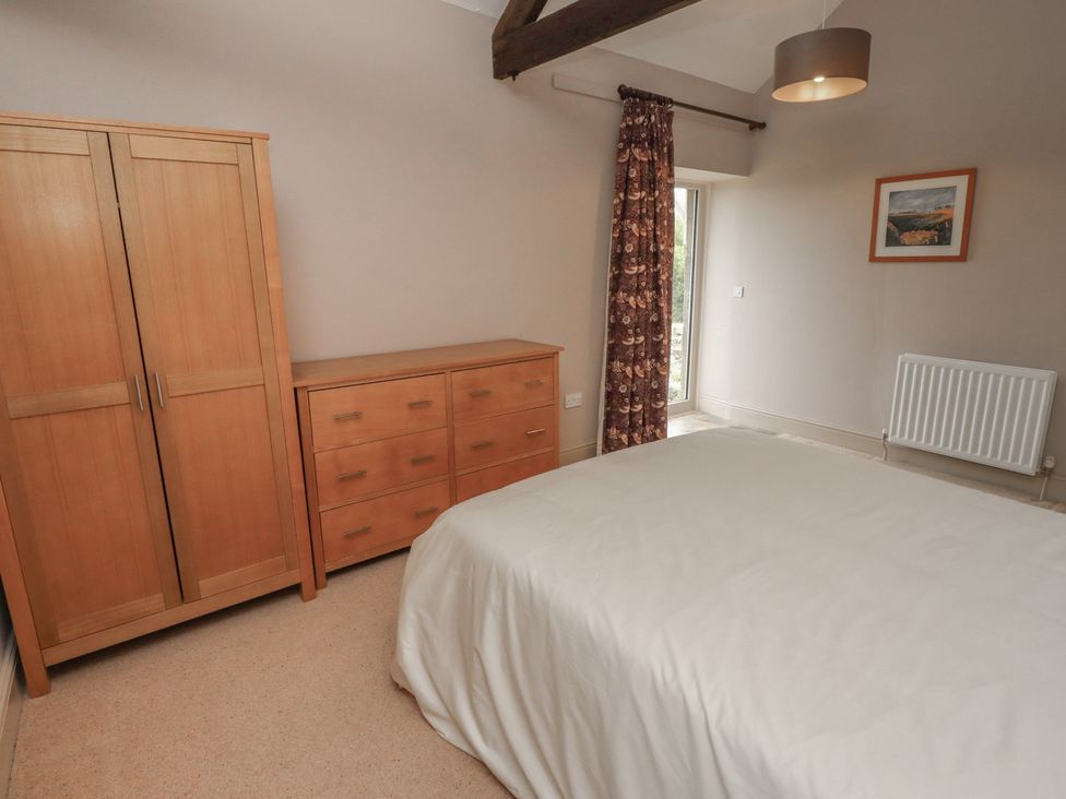A bedroom with a wardrobe and chest of drawers at Annex in Morpeth