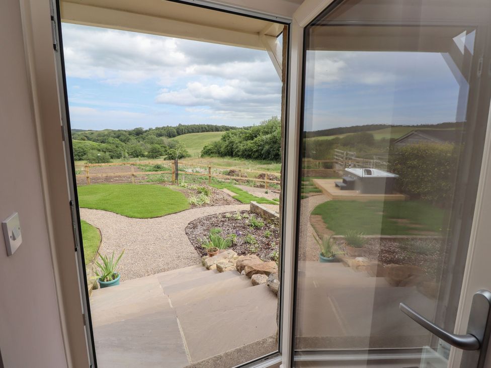 A view of a garden with a path and fence at the Annex in Coldrife near Rothbury