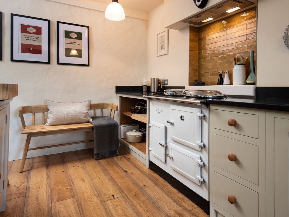A kitchen with an oven, sink, and bench at The Old Coach House in Eglingham near Alnwick