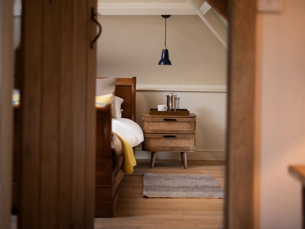 A bedroom featuring a bed and nightstand at The Old Coach House in Eglingham near Alnwick