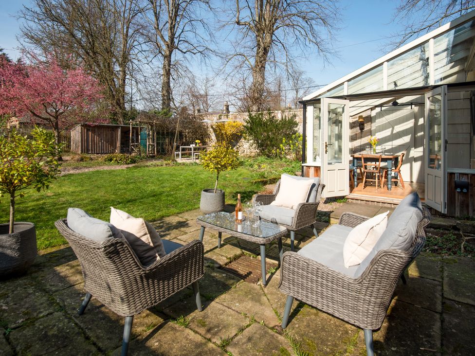 A garden with seating area and table at The Old Coach House Eglingham near Alnwick