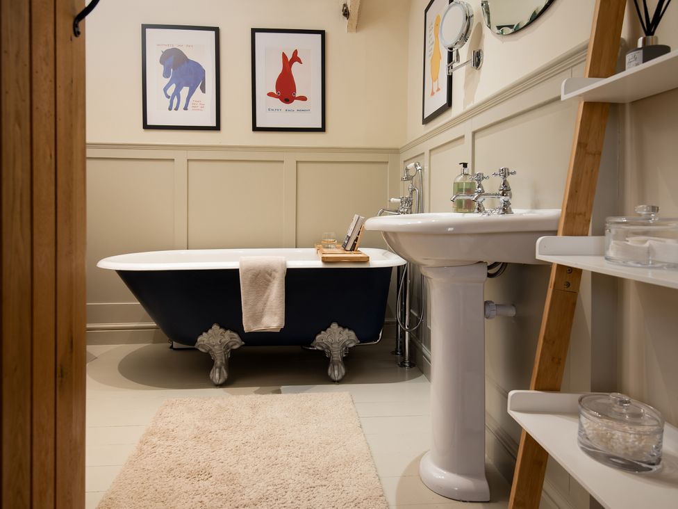 A bathroom with a bathtub and sink at The Old Coach House in Eglingham near Alnwick