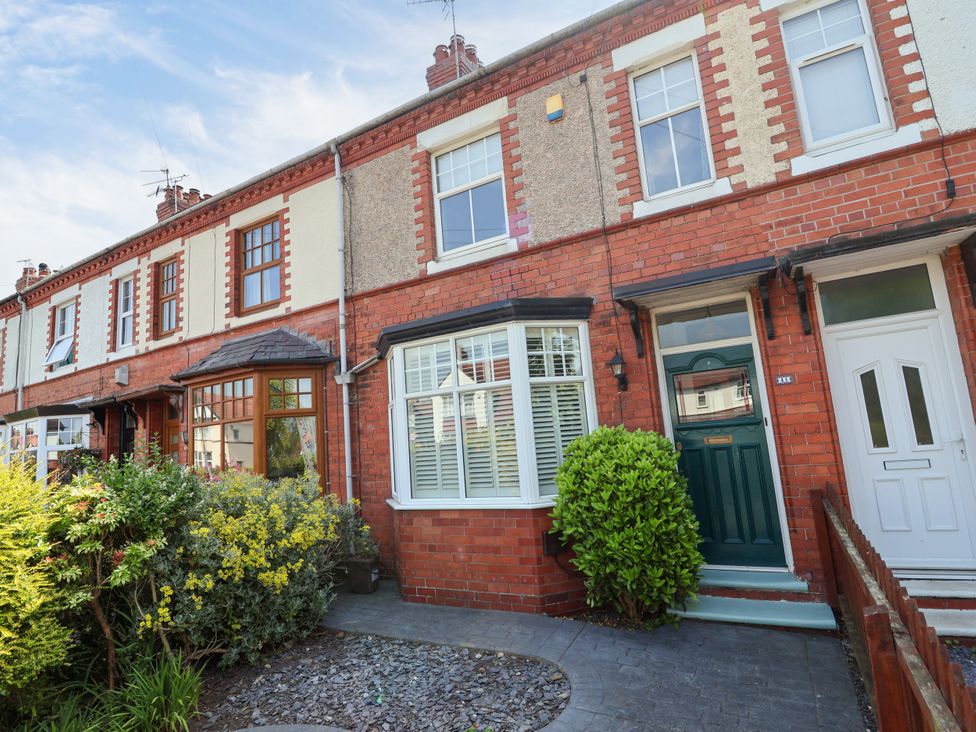 A house with a green front door and windows at 45 Brook Lane Chester