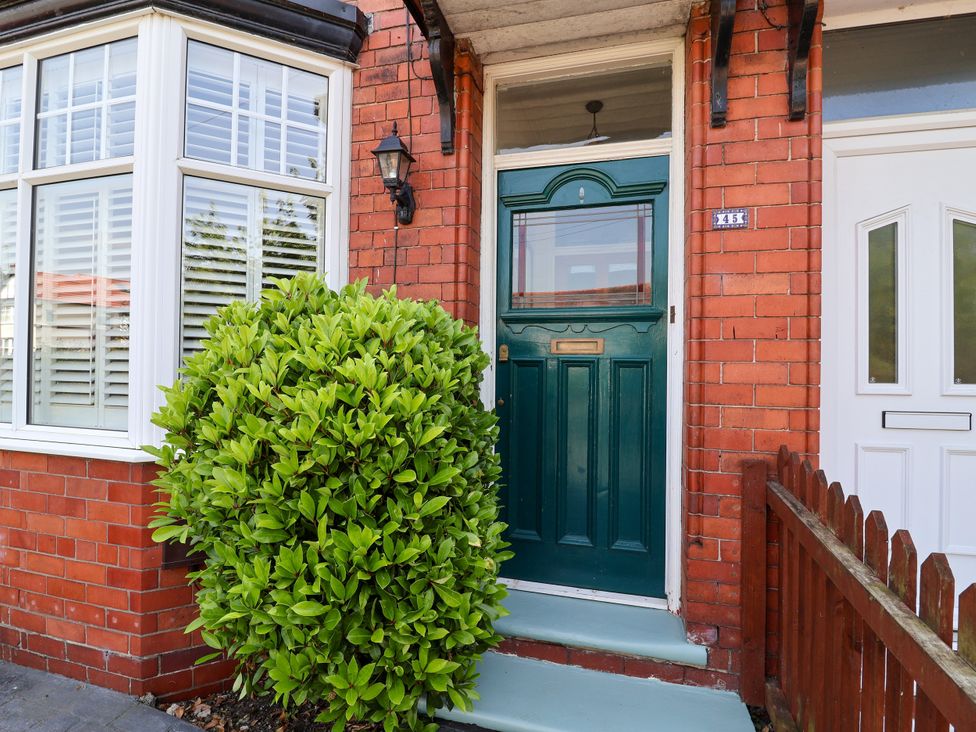 A front entrance with a green door and a bush at 45 Brook Lane Chester