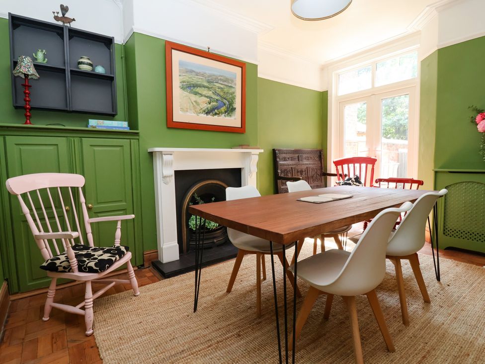A dining room with a wooden table and chairs at 45 Brook Lane Chester