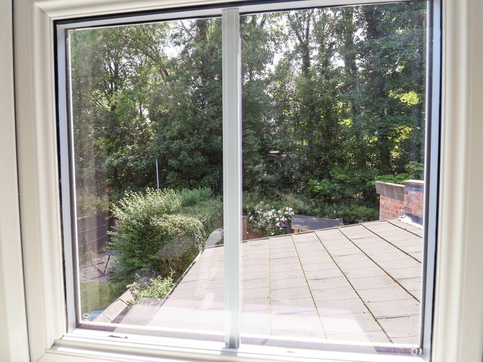 A view from a window showing a roof and greenery at 45 Brook Lane Chester