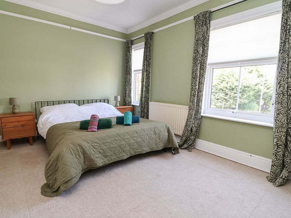 A bedroom with a bed and nightstands at 45 Brook Lane Chester