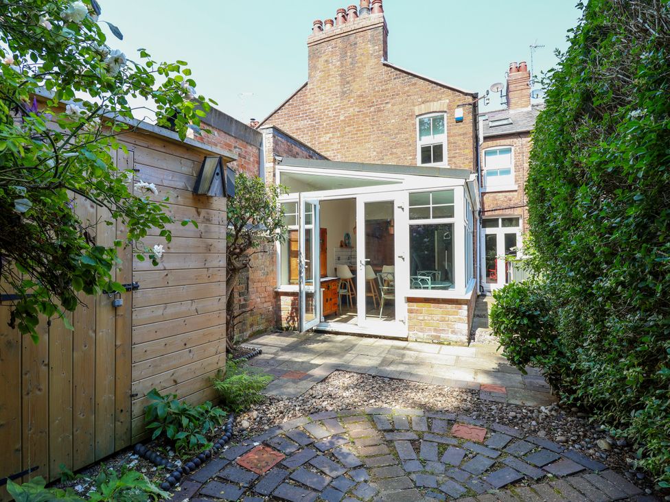 A garden with patio and entrance to house at 45 Brook Lane, Chester