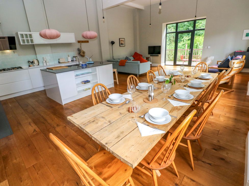A kitchen with a dining table and chairs at The Old Creamery in Ffairfach
