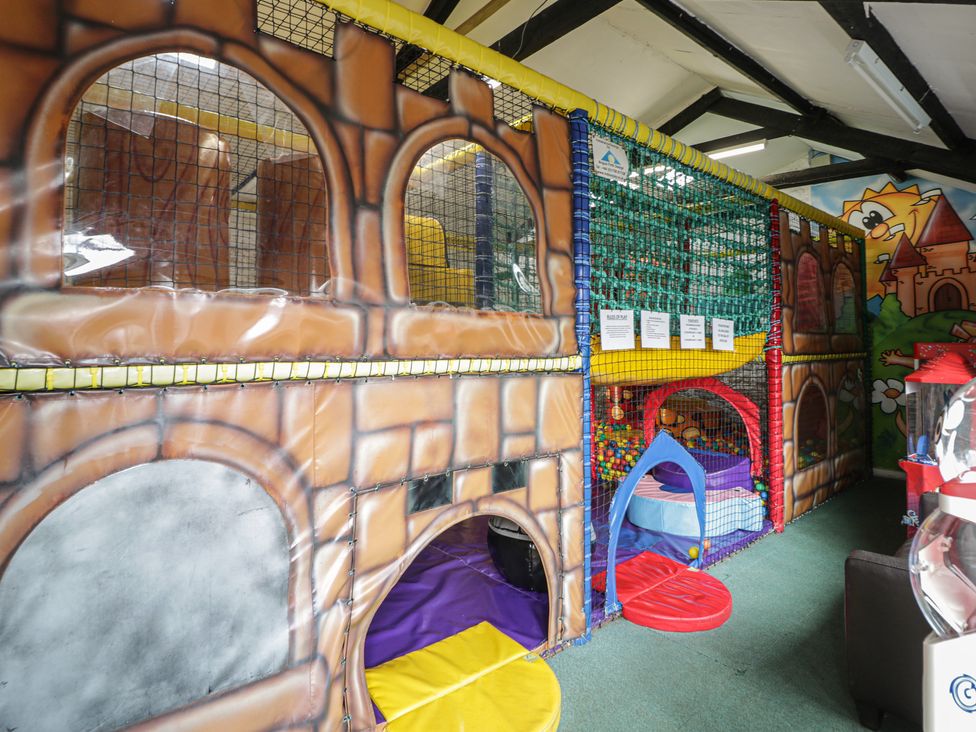 An indoor play area with colorful play structure and soft play equipment at Gold Caravan (316) Talybont