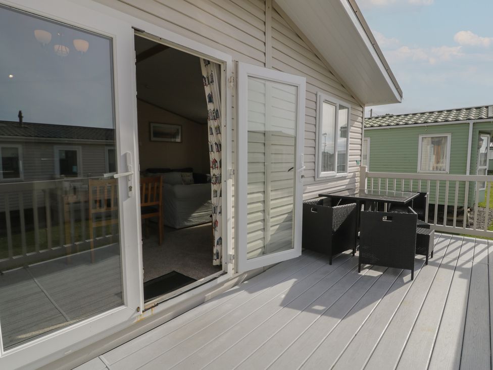 An outdoor area with a table and chairs at Gold Lodge (201) Talybont