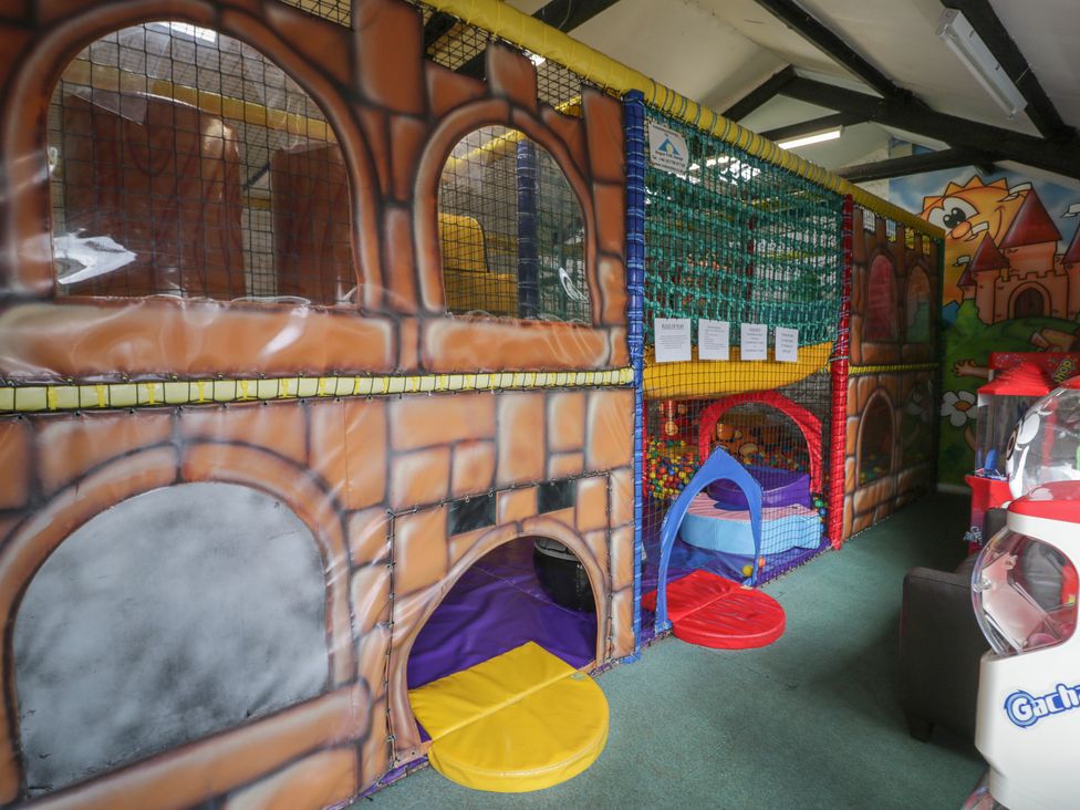 A soft play area with colorful balls and play structure at Gold Lodge (201) Talybont