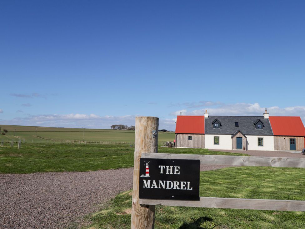A house with a sign in front at The Mandrel in Portmahomack