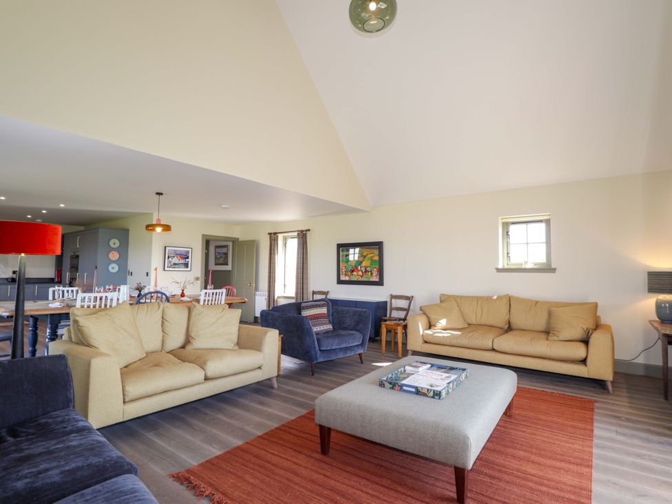 A living room with multiple sofas and an ottoman at The Mandrel in Portmahomack