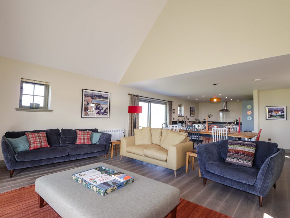 A living room with sofas and a dining area at The Mandrel in Portmahomack