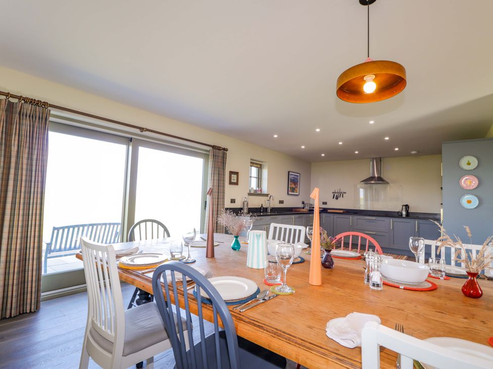 A dining room with a table and chairs at The Mandrel in Portmahomack