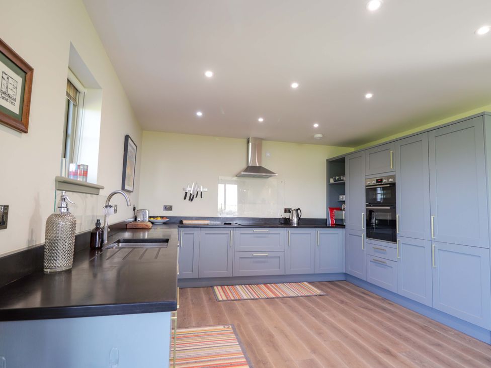 A kitchen with cabinets and appliances at The Mandrel in Portmahomack