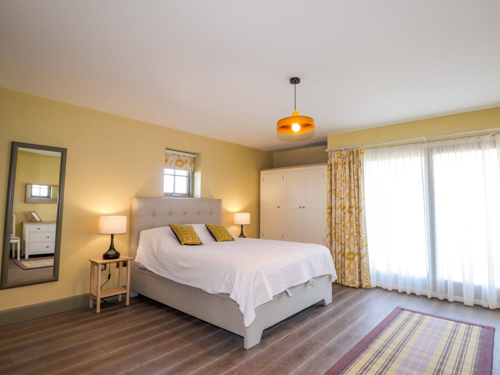 A bedroom with a bed and bedside table at The Mandrel in Portmahomack