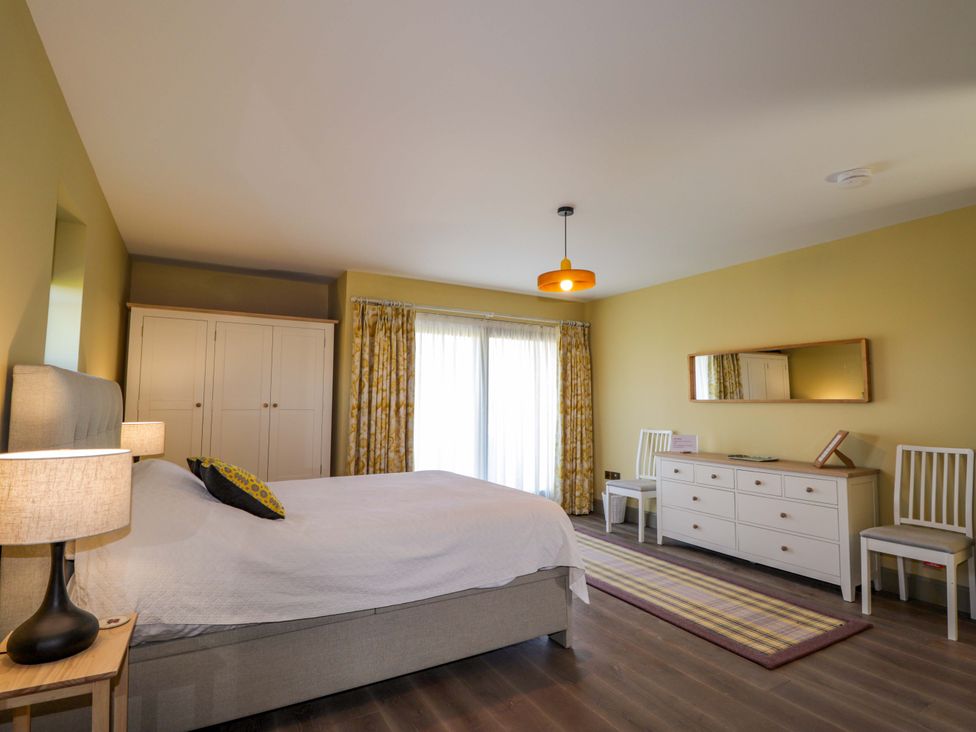 A bedroom featuring a bed, wardrobe, and dresser at The Mandrel in Portmahomack