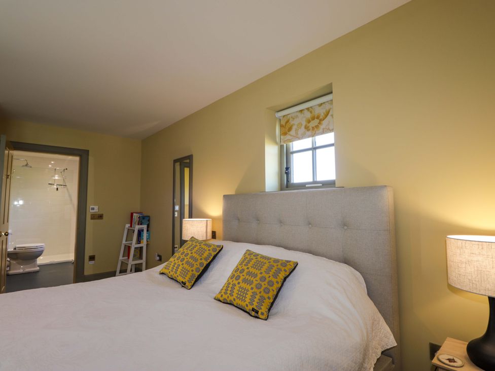 A bedroom with a bed and bedside lamp at The Mandrel in Portmahomack