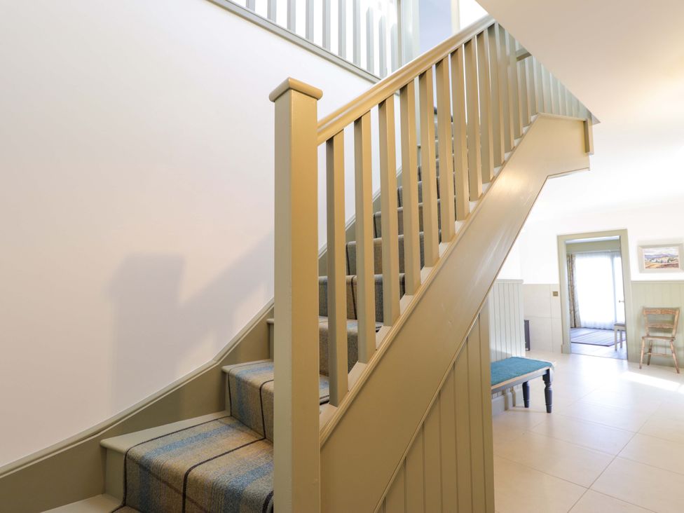A staircase in a hallway at The Mandrel in Portmahomack