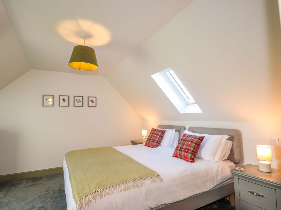 A bedroom with a bed and bedside tables at The Mandrel in Portmahomack