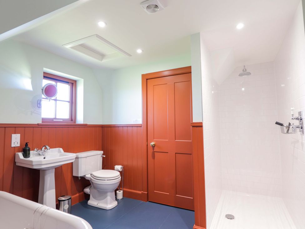 A bathroom with a sink, toilet, and shower at The Mandrel in Portmahomack