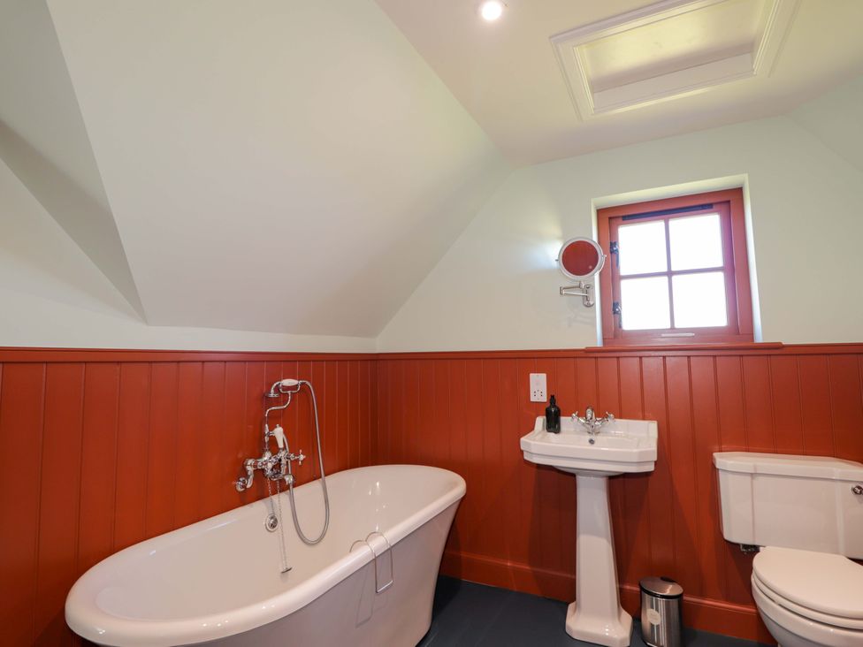 A bathroom with a bath tub, sink, and toilet at The Mandrel in Portmahomack