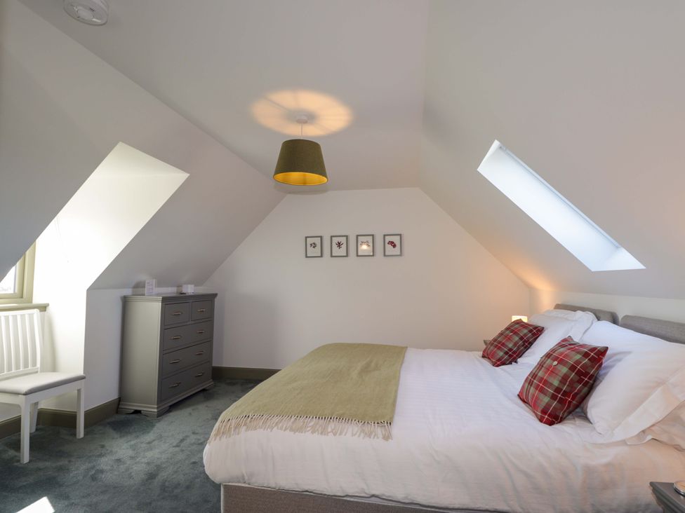 A bedroom with a bed and chest of drawers at The Mandrel in Portmahomack
