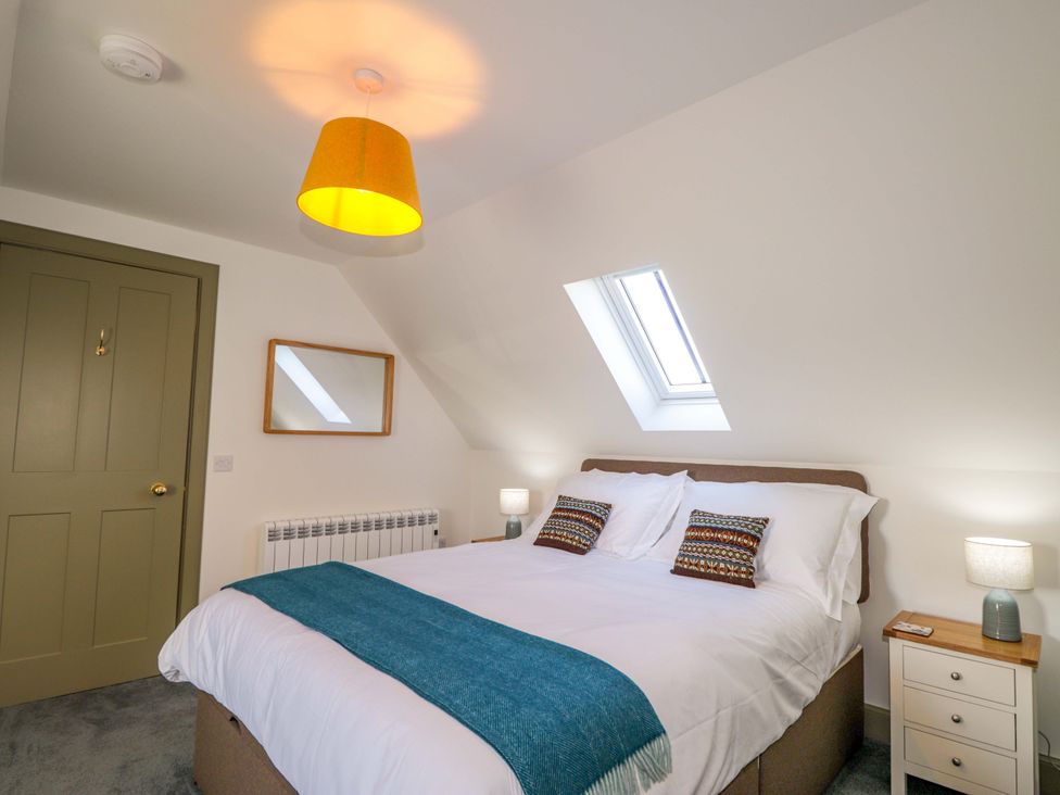 A bedroom with a bed and a nightstand at The Mandrel in Portmahomack