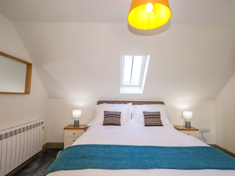 A bedroom with a bed and bedside tables at The Mandrel in Portmahomack