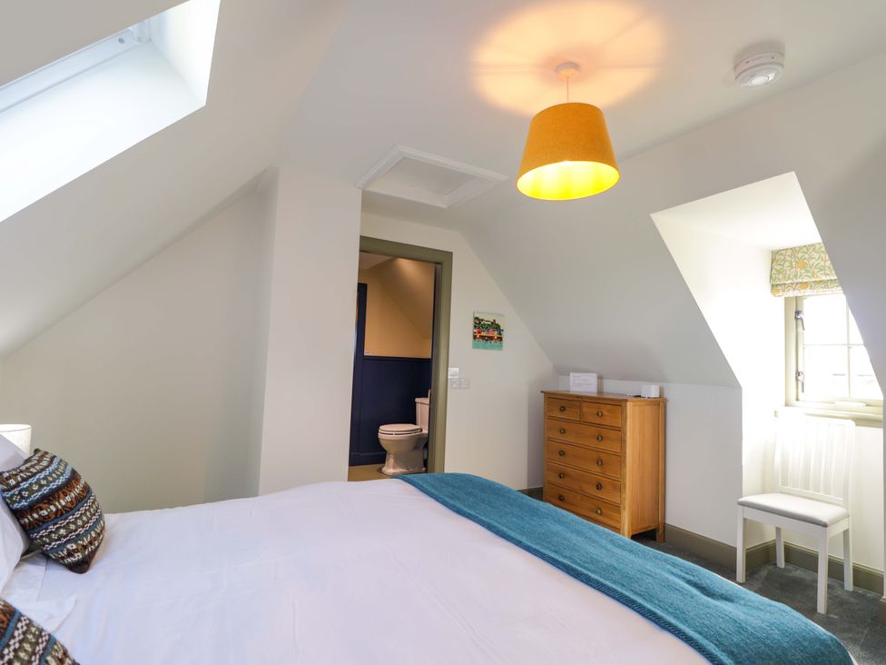 A bedroom with a bed and a chest of drawers at The Mandrel in Portmahomack