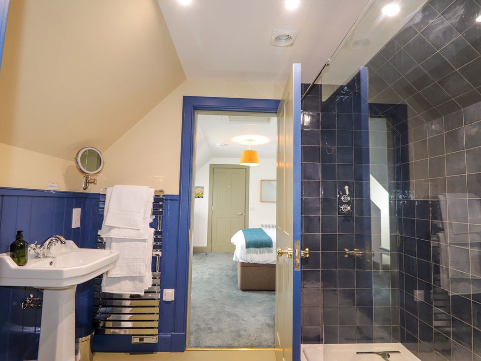 A bathroom with a washbasin and a shower at The Mandrel in Portmahomack