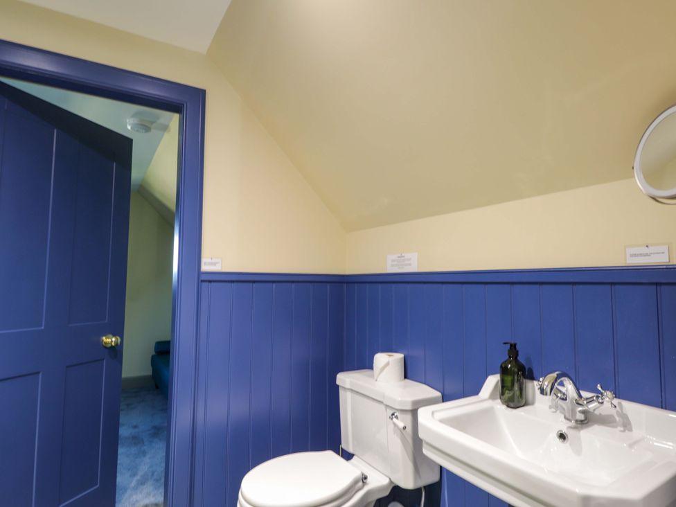 A bathroom with a white toilet and sink at The Mandrel in Portmahomack