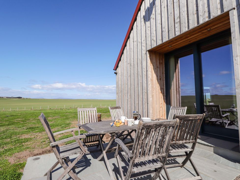 An outdoor patio with a table and chairs at The Mandrel in Portmahomack