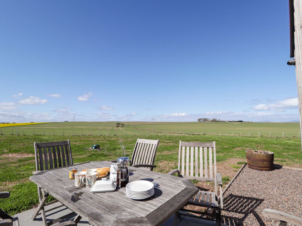An outdoor dining setup with a table and chairs at The Mandrel in Portmahomack