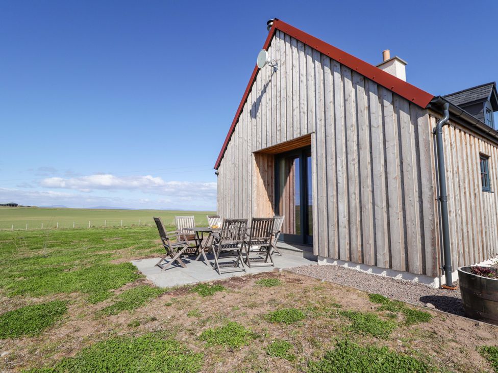 An outdoor patio area with table and chairs at The Mandrel in Portmahomack