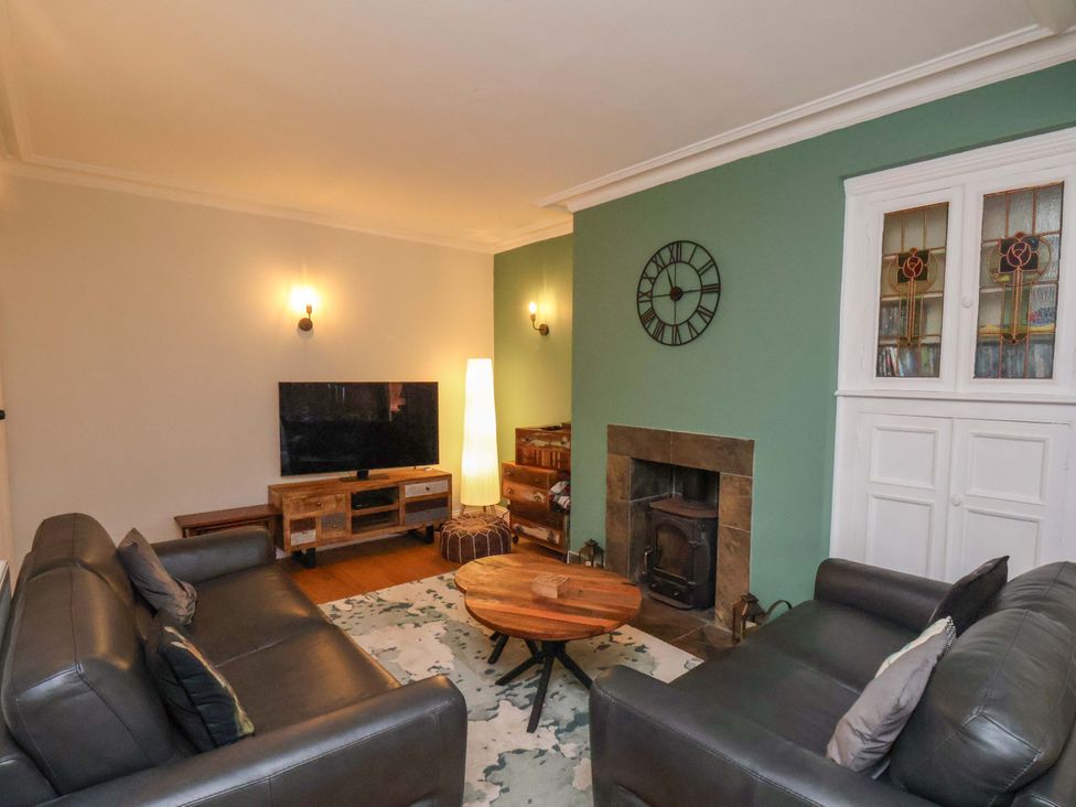 A living room with a TV and coffee table at Falcon's Nest in Whitby